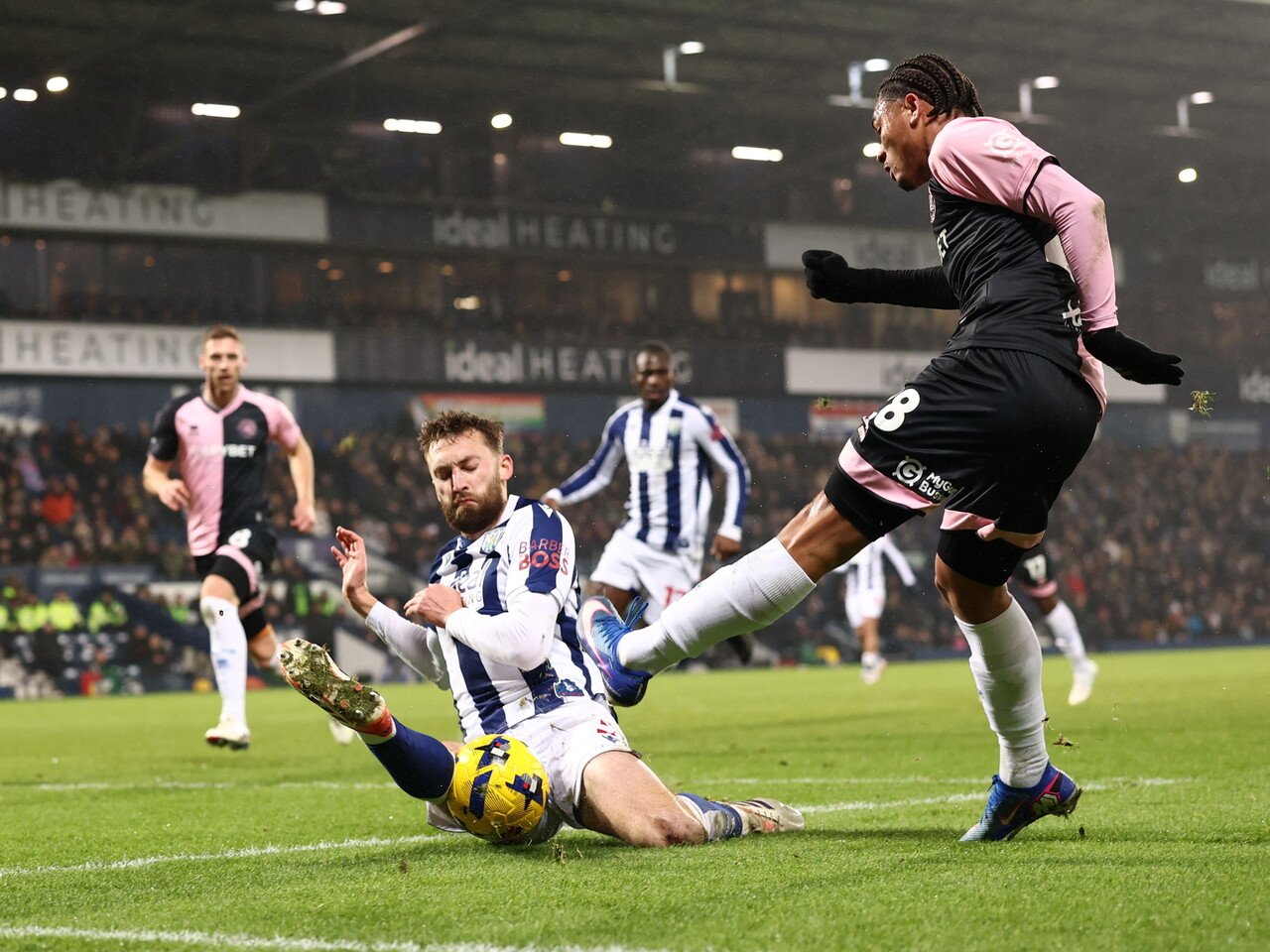 Nat Phillips making a lunging tackle on a QPR player