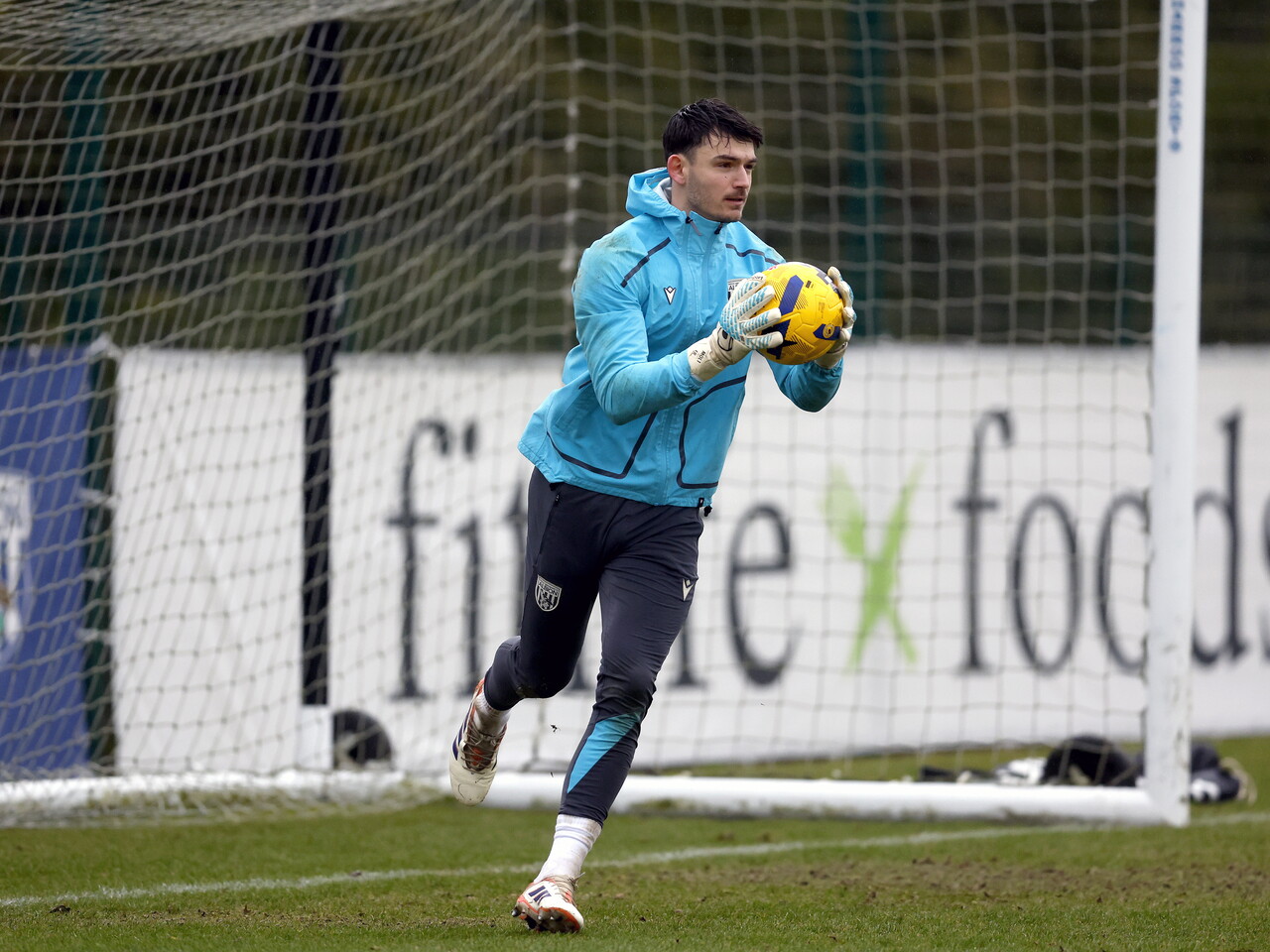 Max O'Leary holding a ball in training