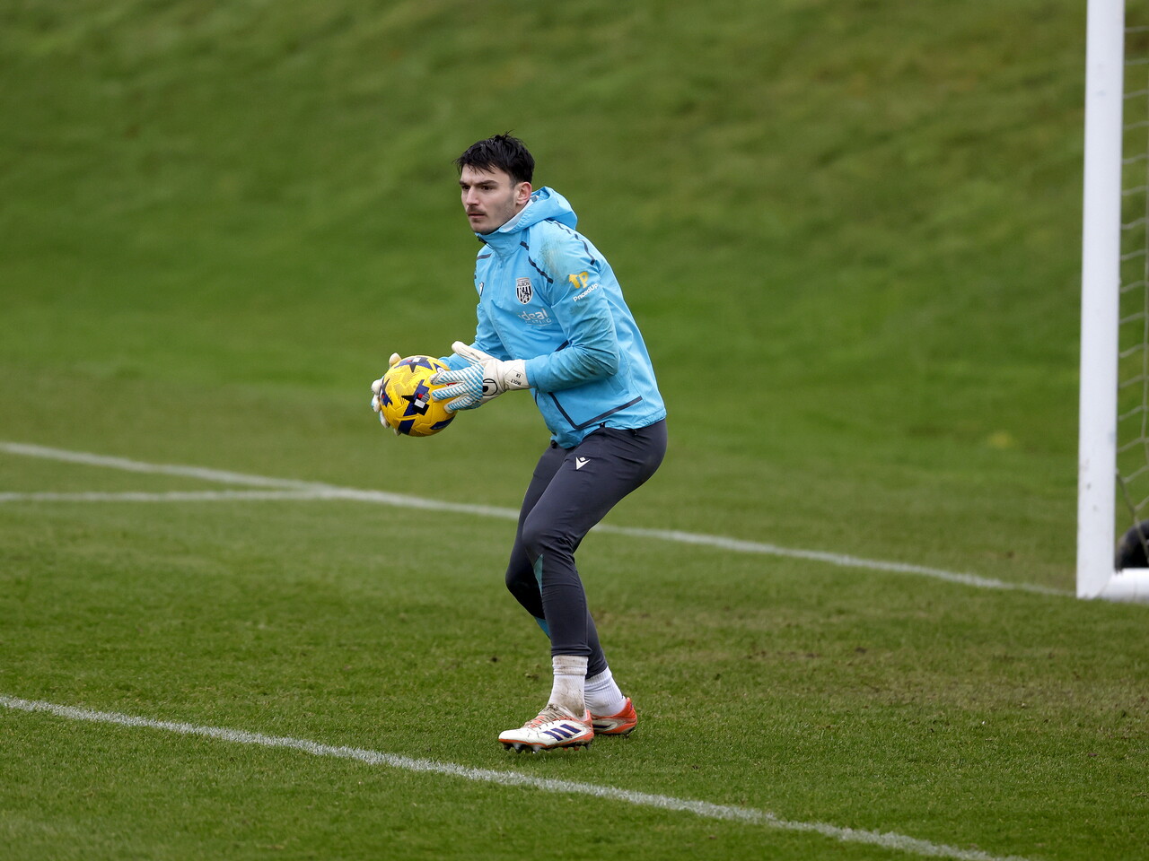 Max O'Leary holding a ball in training
