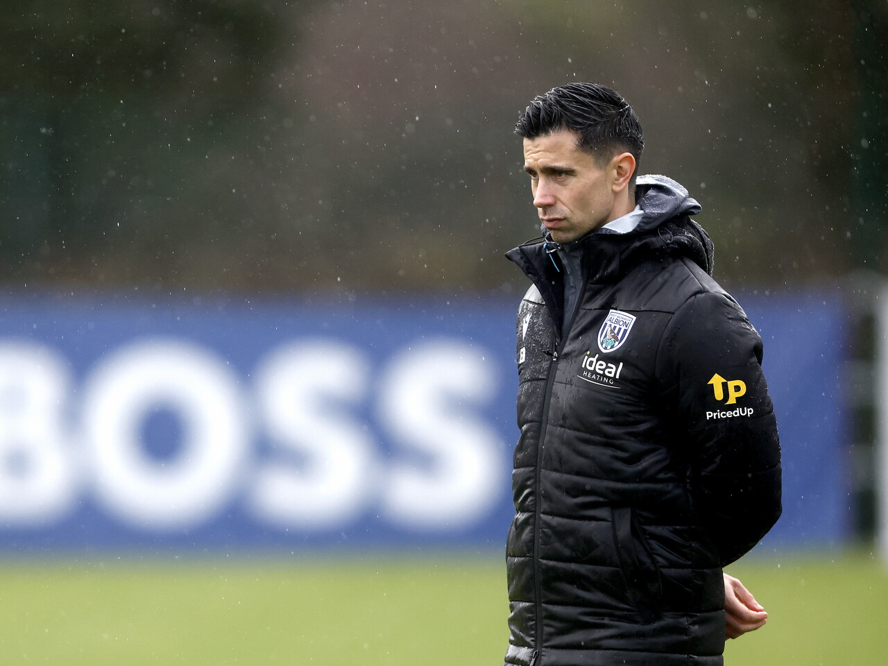 Eric Ramsay watching training in the rain