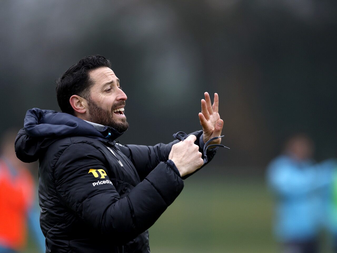 Damia Abella delivering instructions to players during a training session
