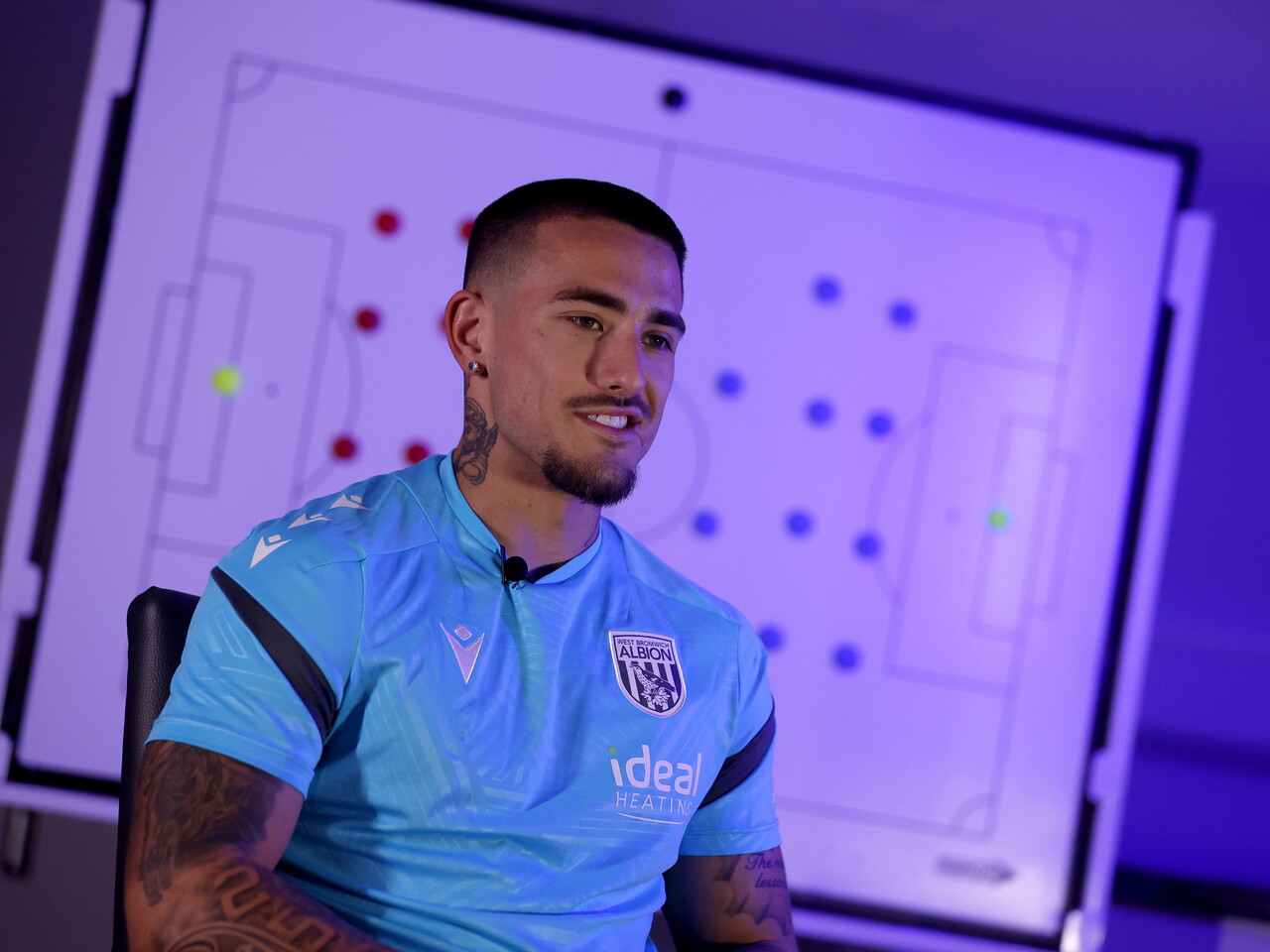 Danny Imray smiling while being interviewed by WBA TV while sat in front of a tactics board