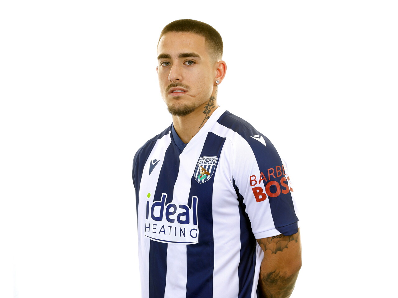 Danny Imray smiling at the camera while stood in front of a white background in a home WBA shirt