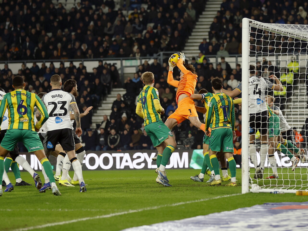 General action of Derby v WBA with the Derby keeper catching the ball in a crowded penalty area