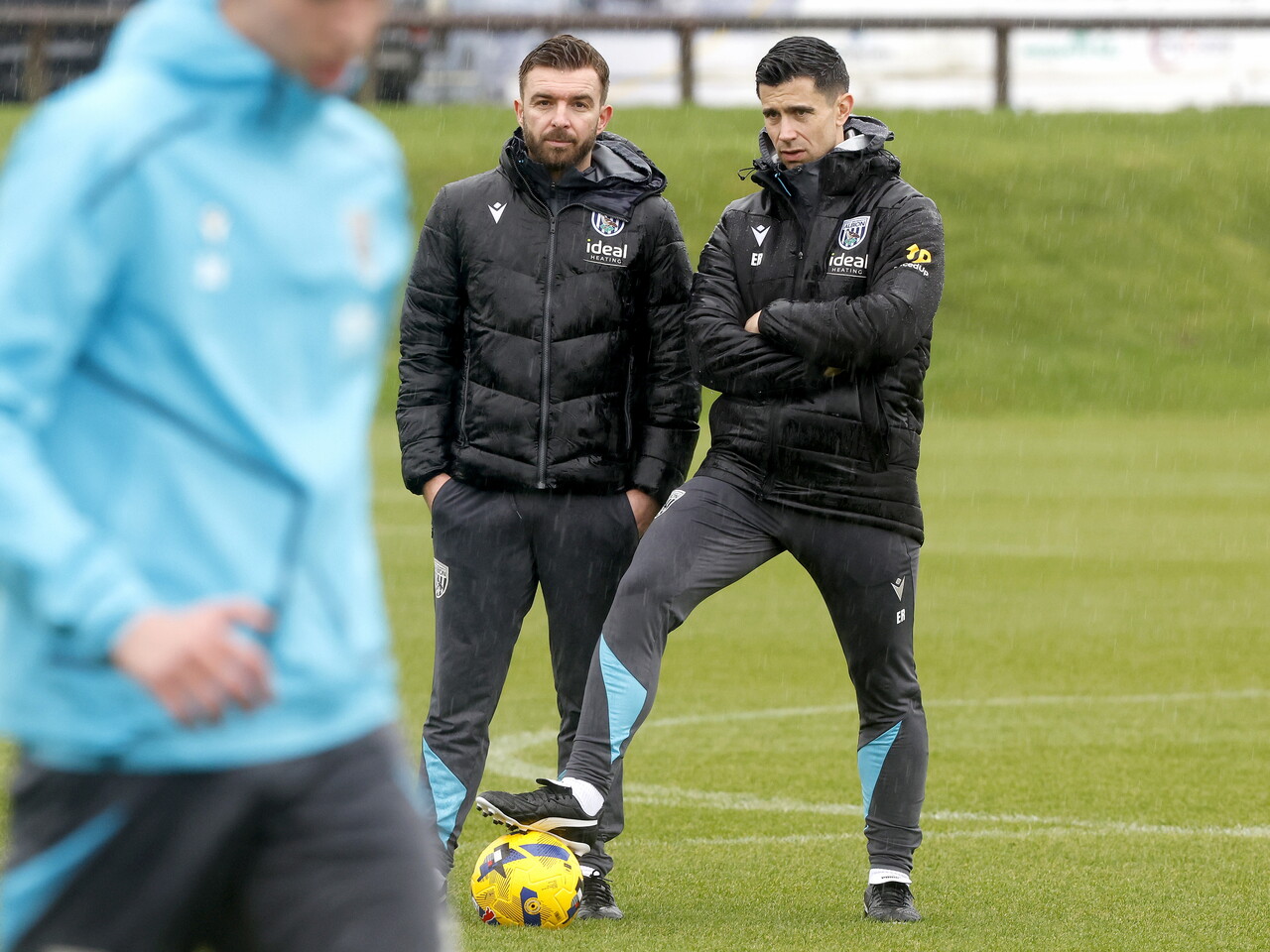 Eric Ramsay watching training in the rain while stood next to James Morrison