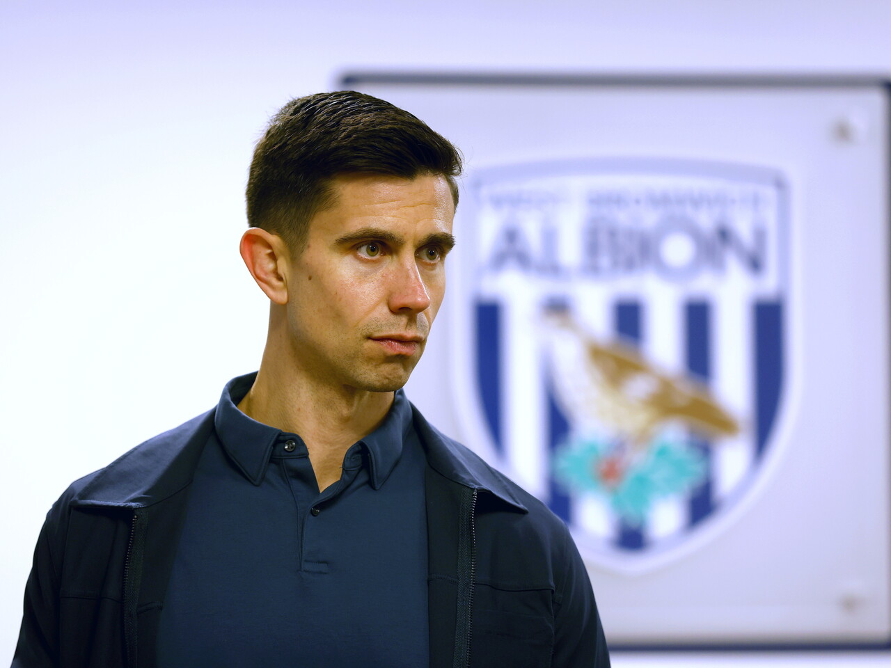 Eric Ramsay in front of a WBA badge 