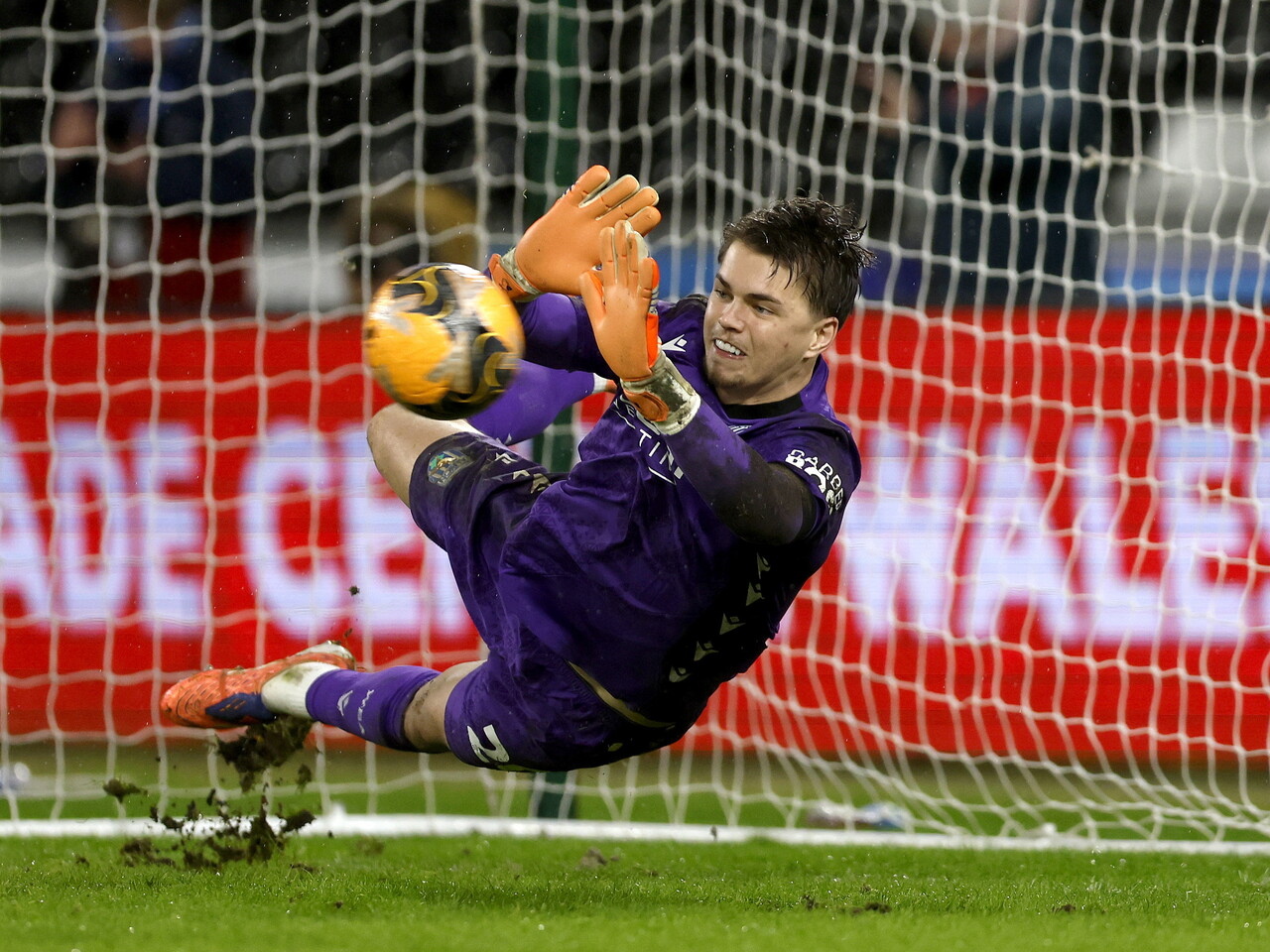 Josh Griffiths saves the penalty.
