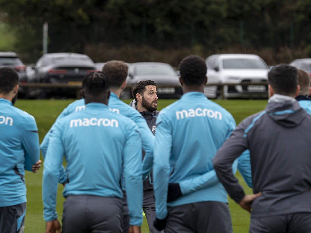 Damia Abella delivering messages to WBA players in a huddle during a training session