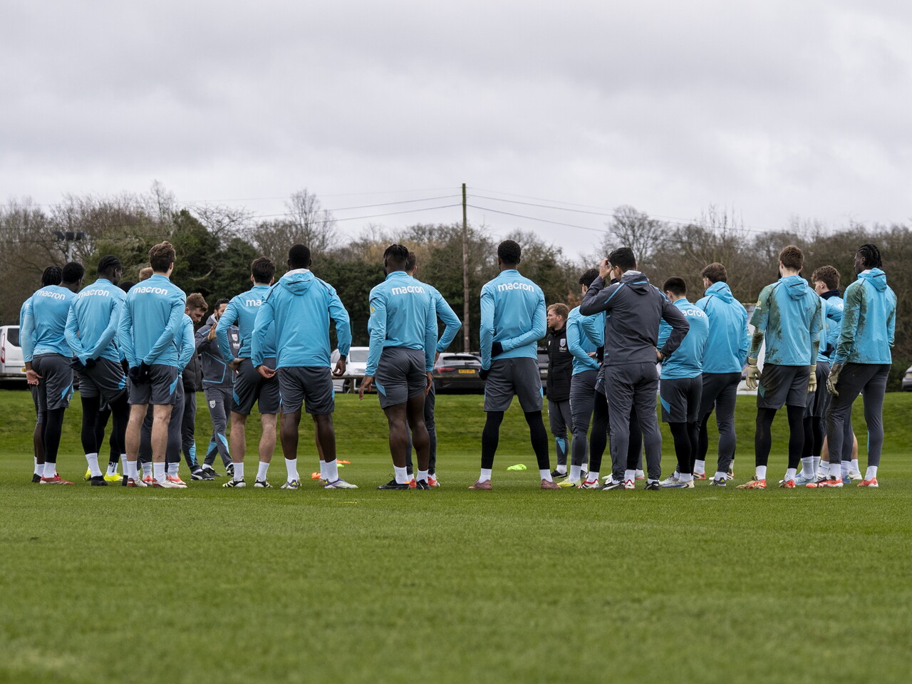 WBA players and staff in a huddle in the middle of the training session