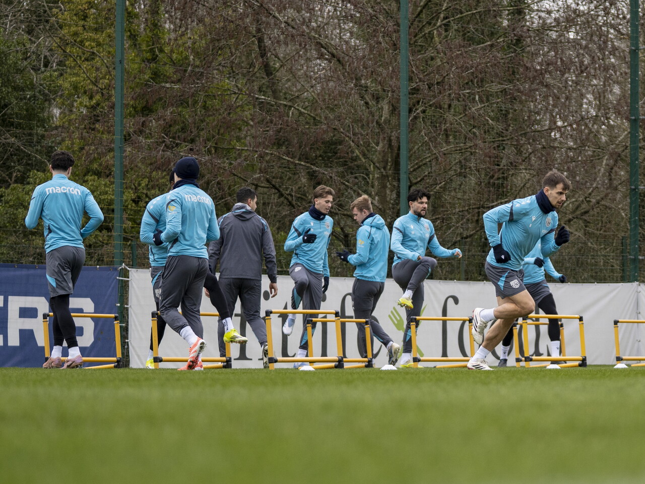 Several players completing a warm-up drill during training 