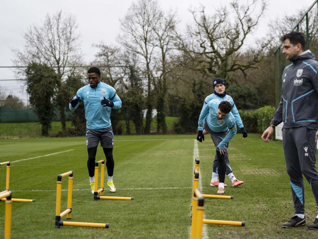 Josh Maja, Callum Styles and Mikey Johnston warming up before a training session