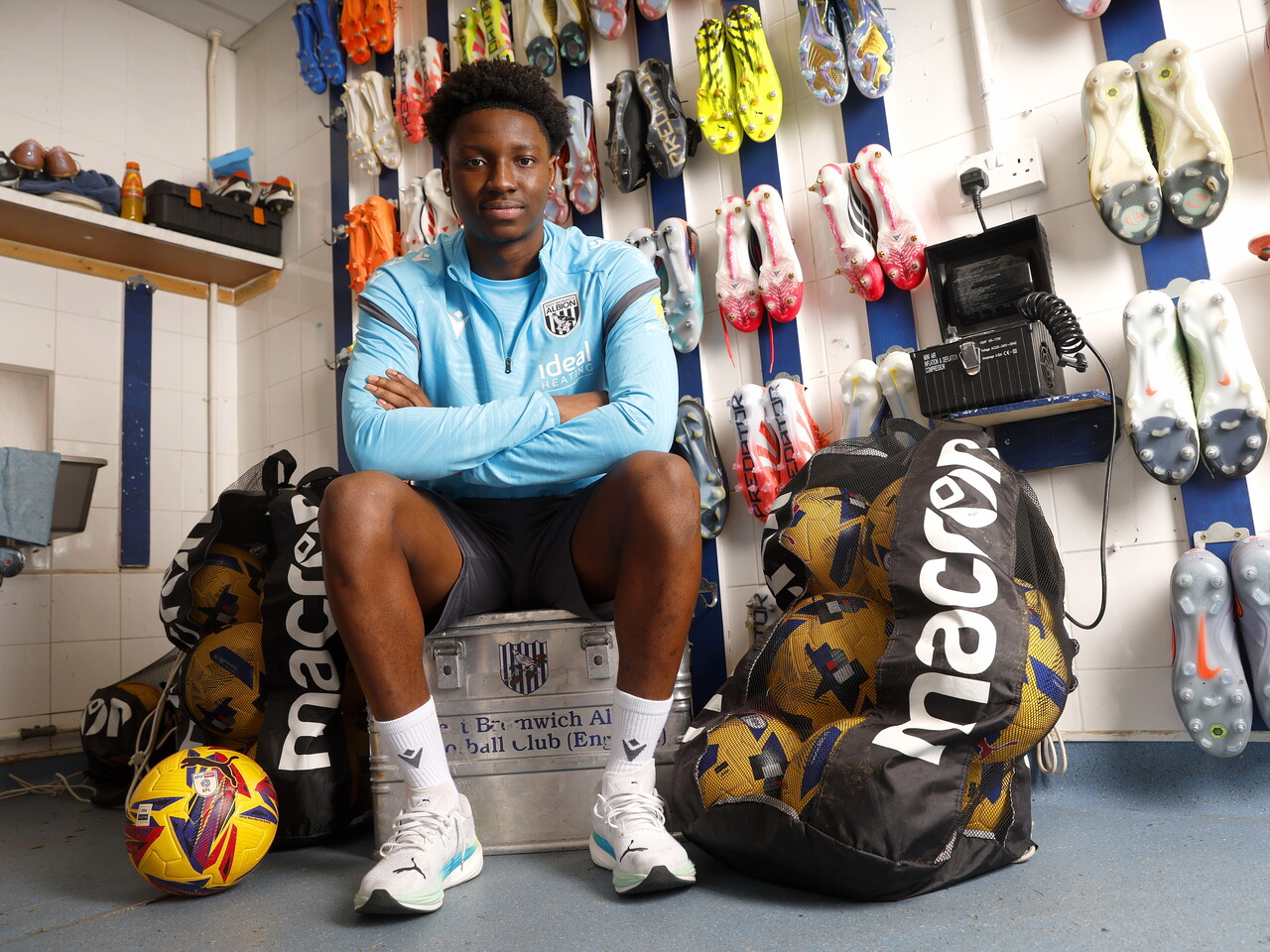Jamaldeen Jimoh-Aloba smiling at the camera while sat in the boot room