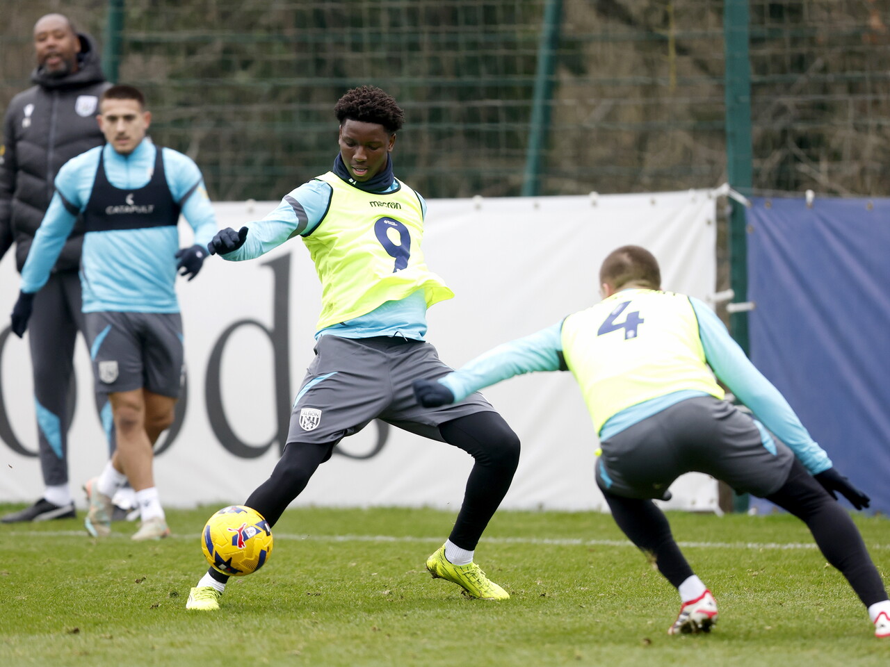 Jamaldeen Jimoh-Aloba on the ball during a training session while wearing a yellow bib