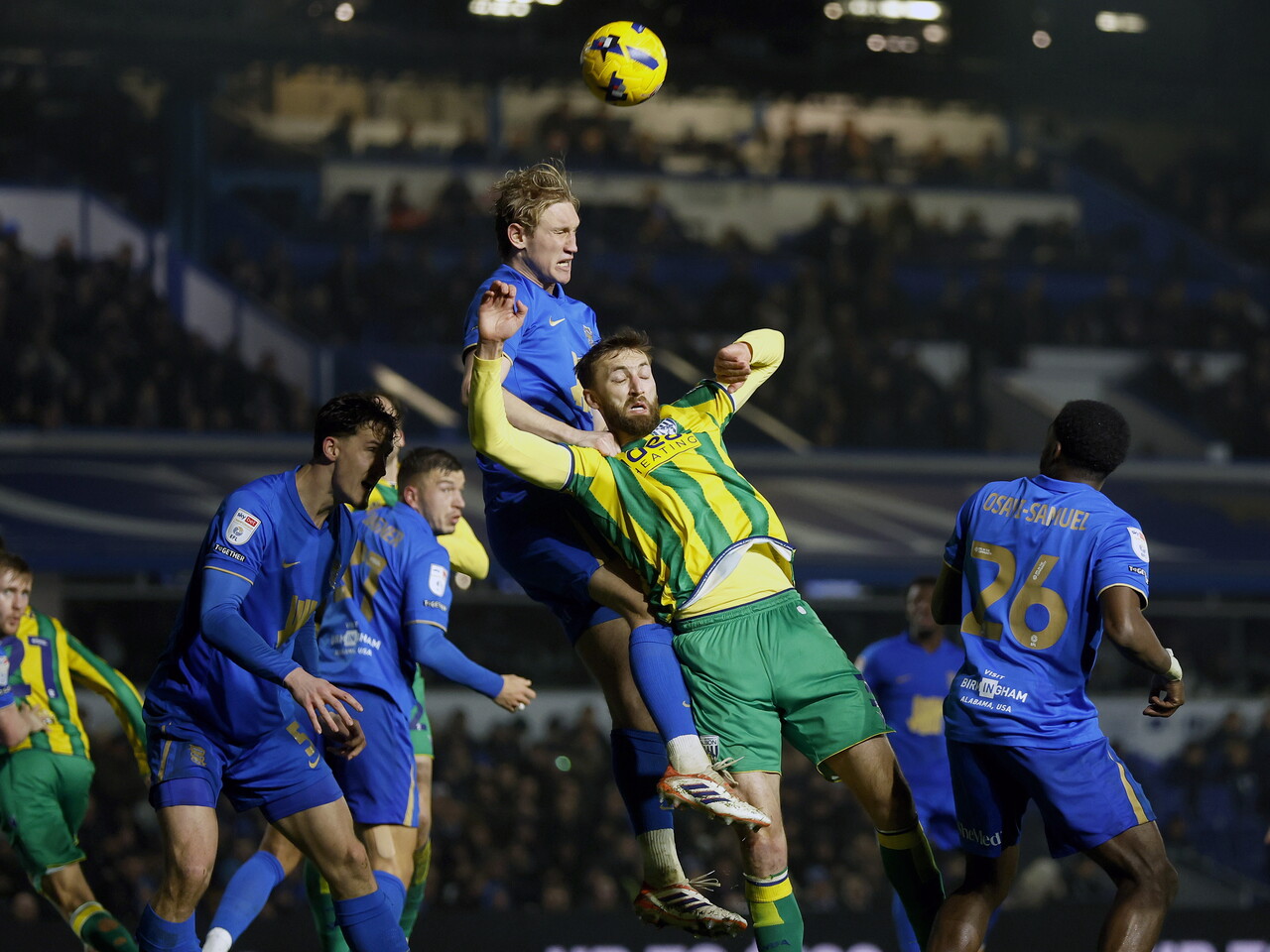 Nat Phillips jumps to try and win a header against a Blues defender 