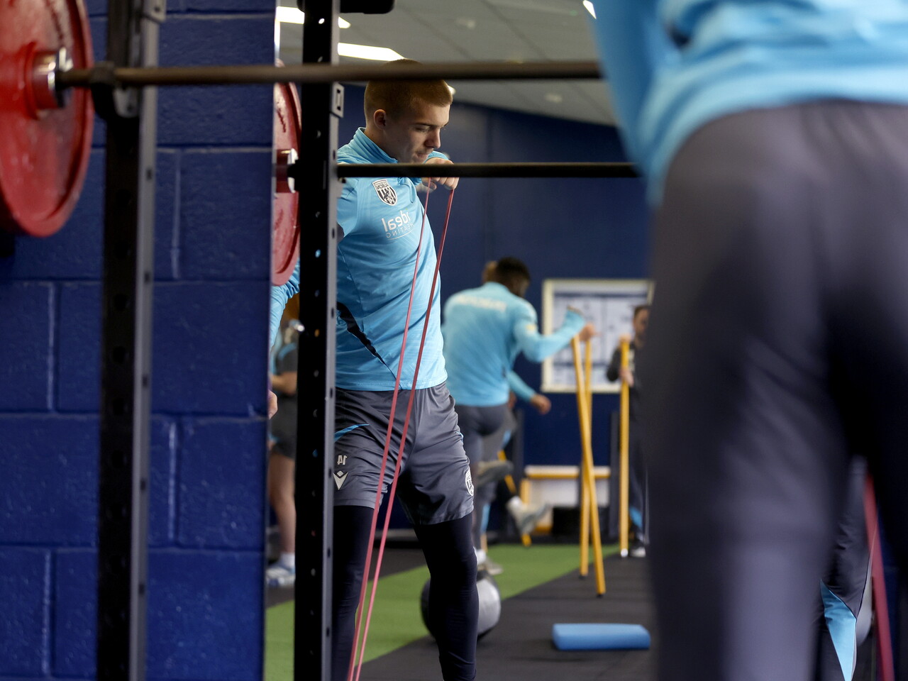 Alfie Gilchrist stretching in the gym