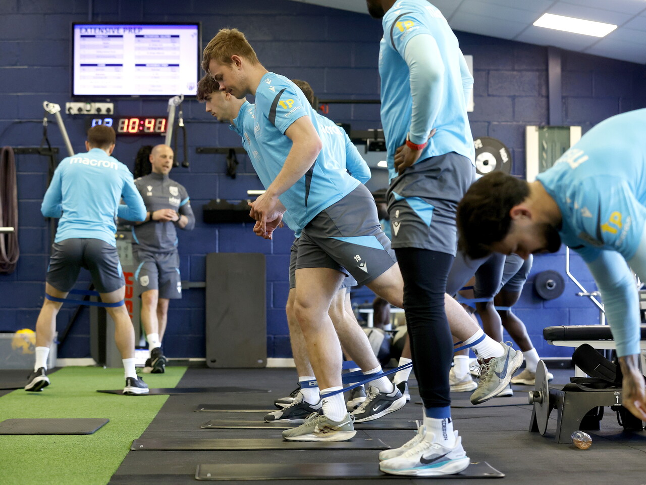 Several WBA players working with resistance bands in the gym