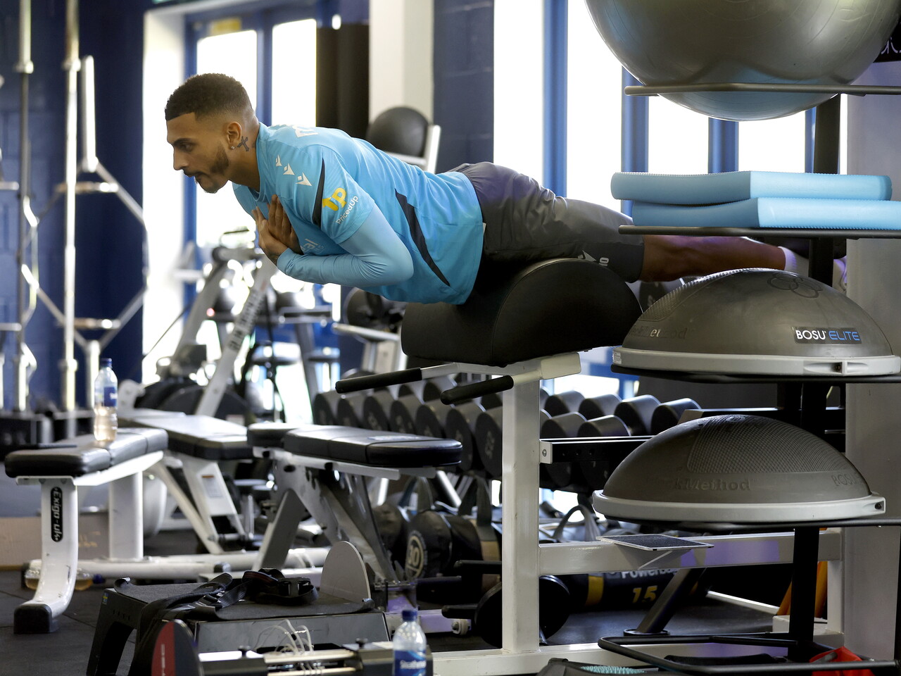 Karlan Grant stretching in the gym
