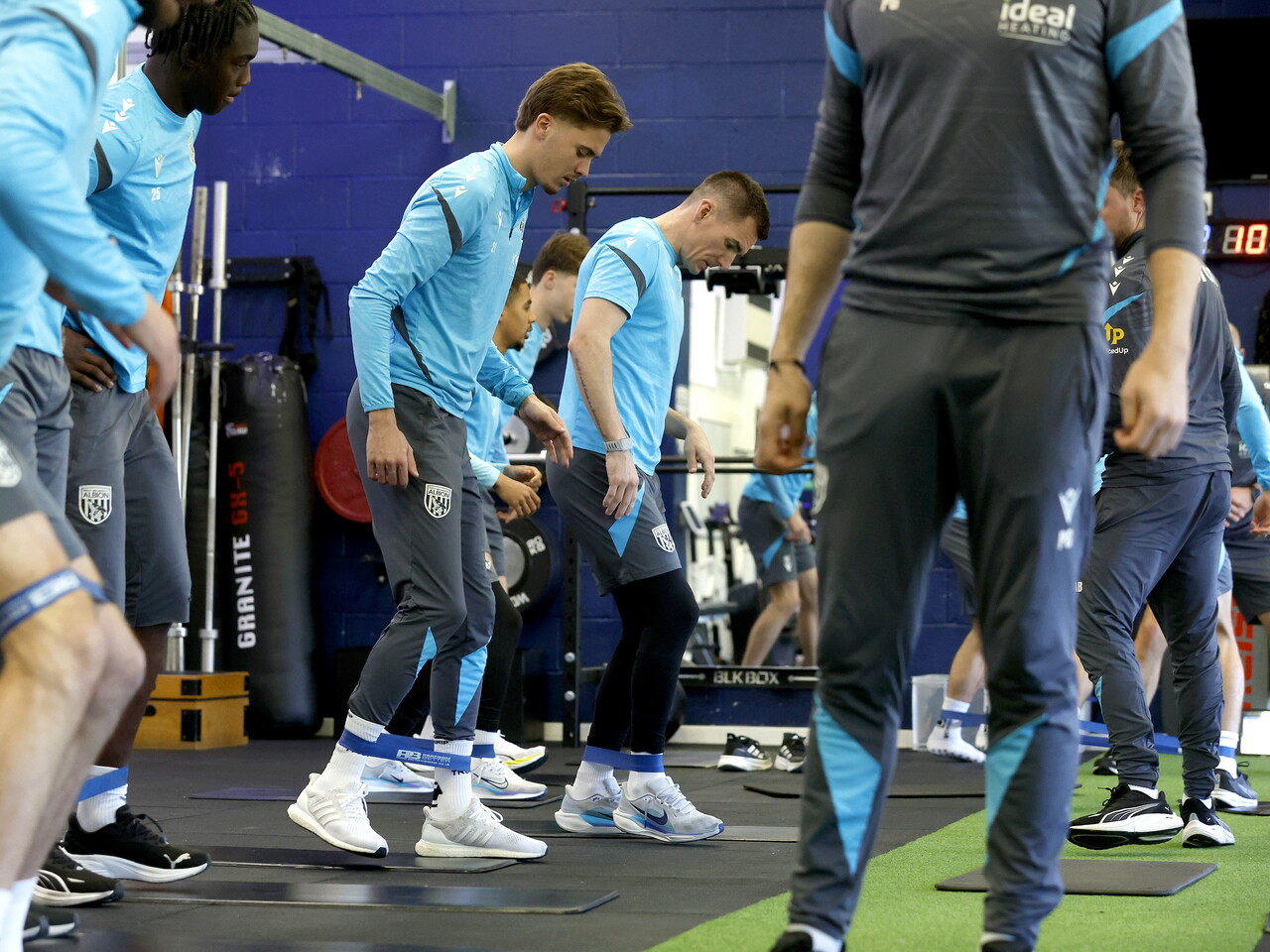 Several WBA players working with resistance bands in the gym