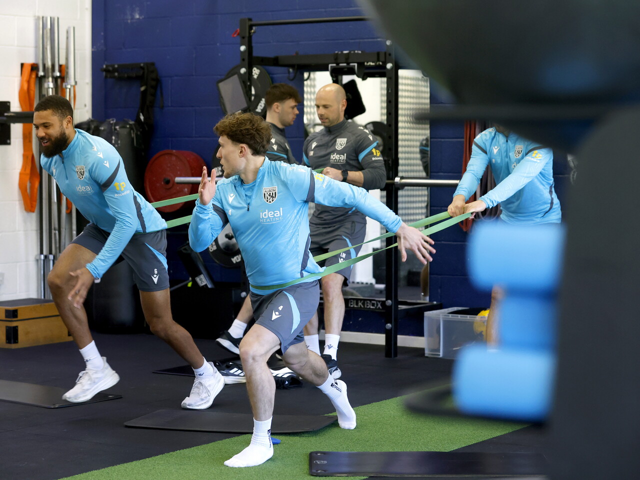 Callum Styles and George Campbell working with resistance bands in the gym