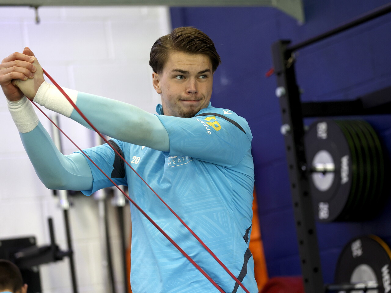Josh Griffiths stretching in the gym