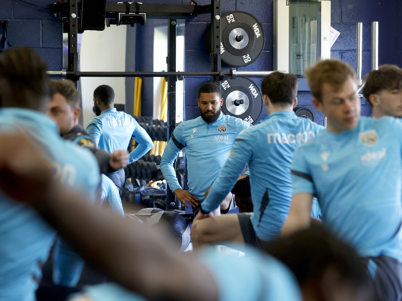 Several WBA players stretching in the gym