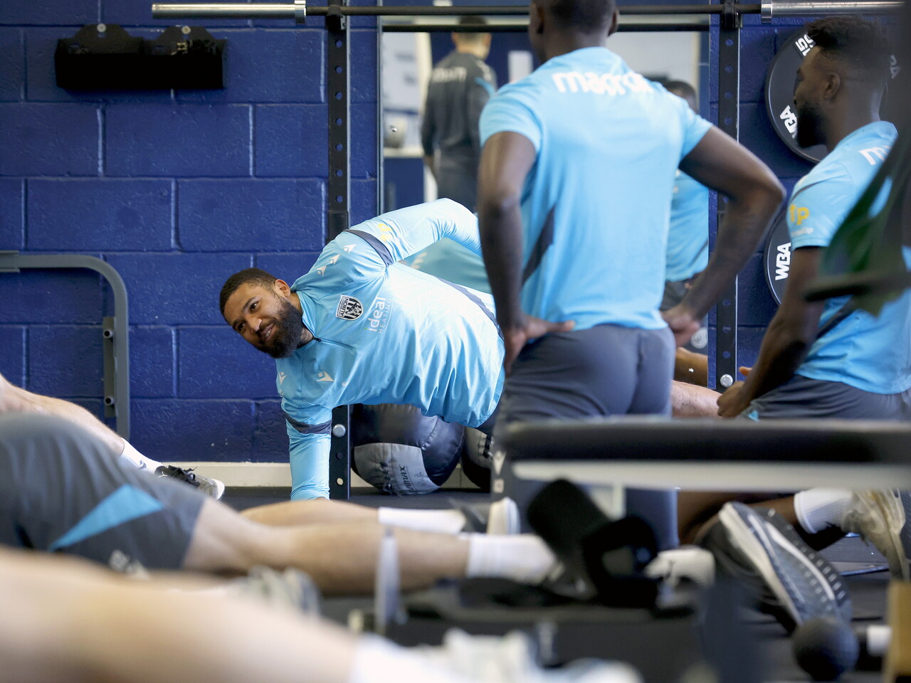 Several WBA players stretching in the gym