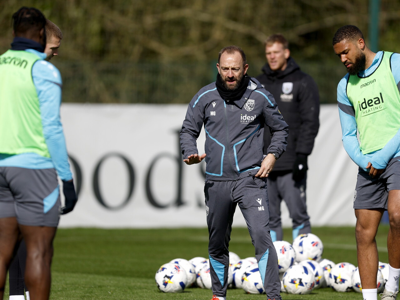 Matt Gill delivering instructions to players on the training pitch 
