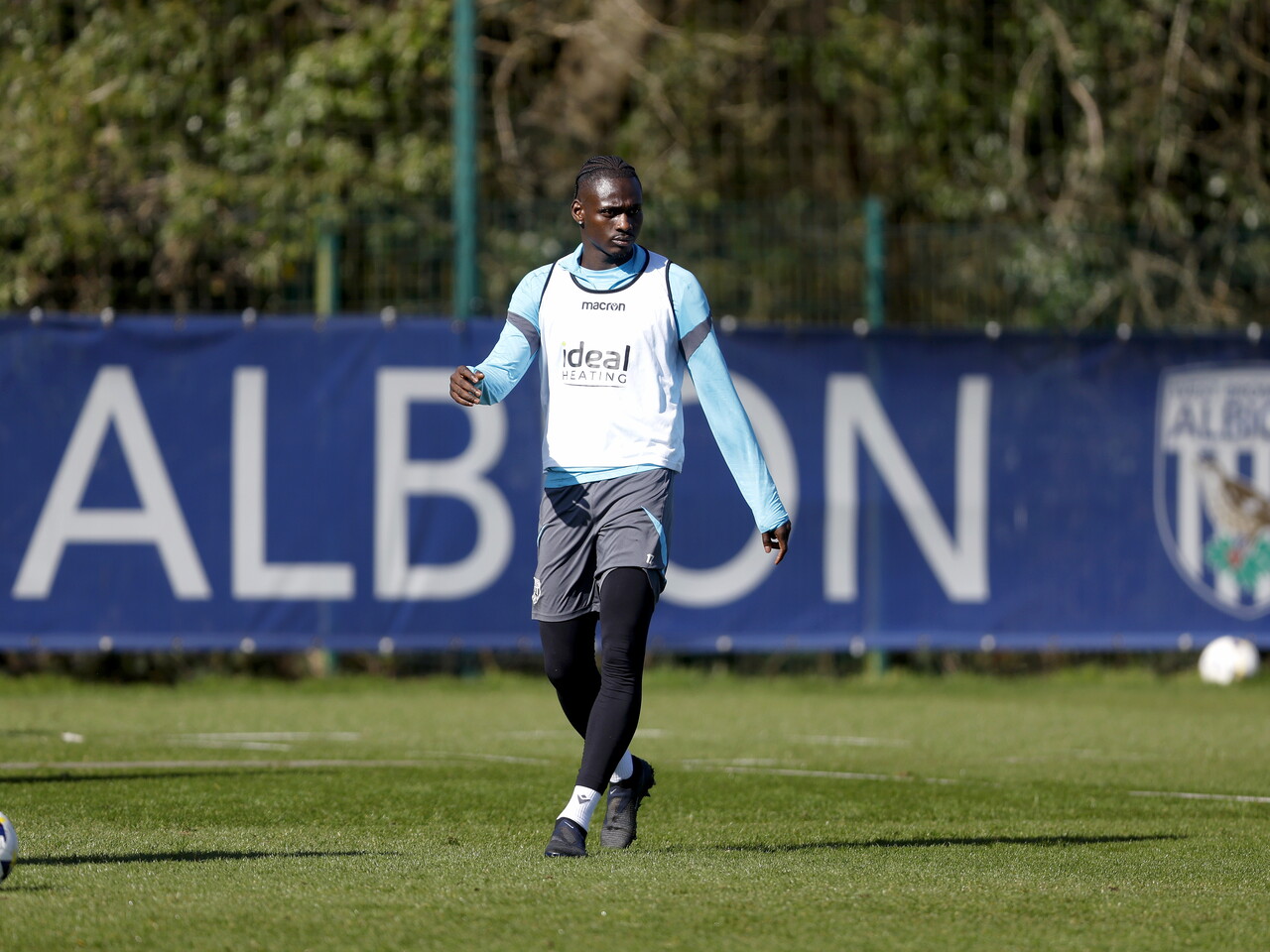 Ousmane Diakité in front of a sign which reads 'Albion' during a training session