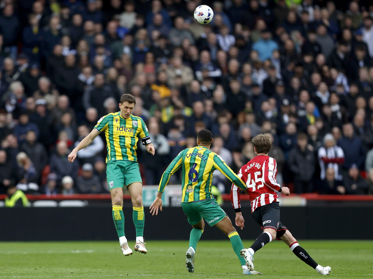 Krystian Bielik heading the ball away against Sheffield United 