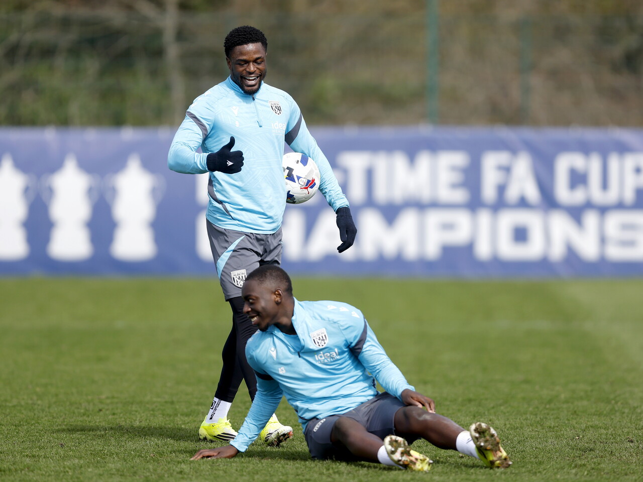 Josh Maja standing over Eseosa Sule on the floor and laughing 