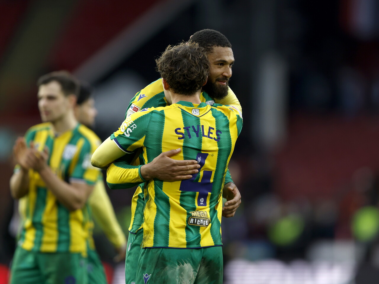 George Campbell and Callum Styles hug after the Sheffield United game
