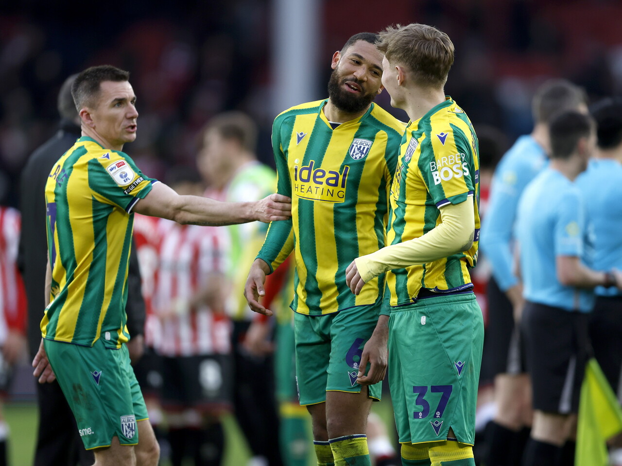 George Campbell and Ollie Bostock smiling and talking after the Sheffield United game