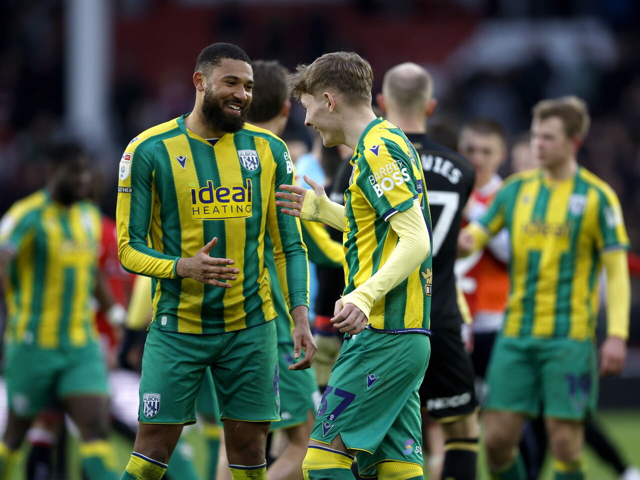 George Campbell and Ollie Bostock smiling and talking after the Sheffield United game