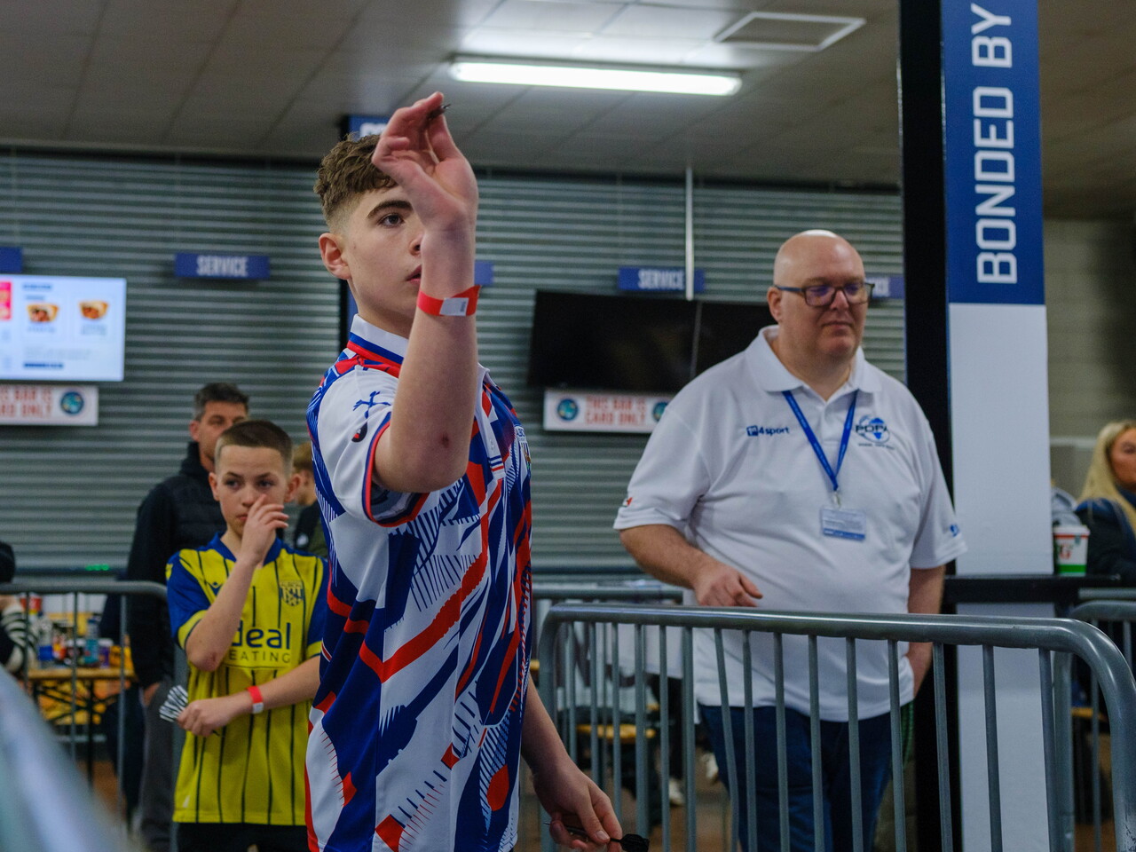Junior players ready to throw a dart