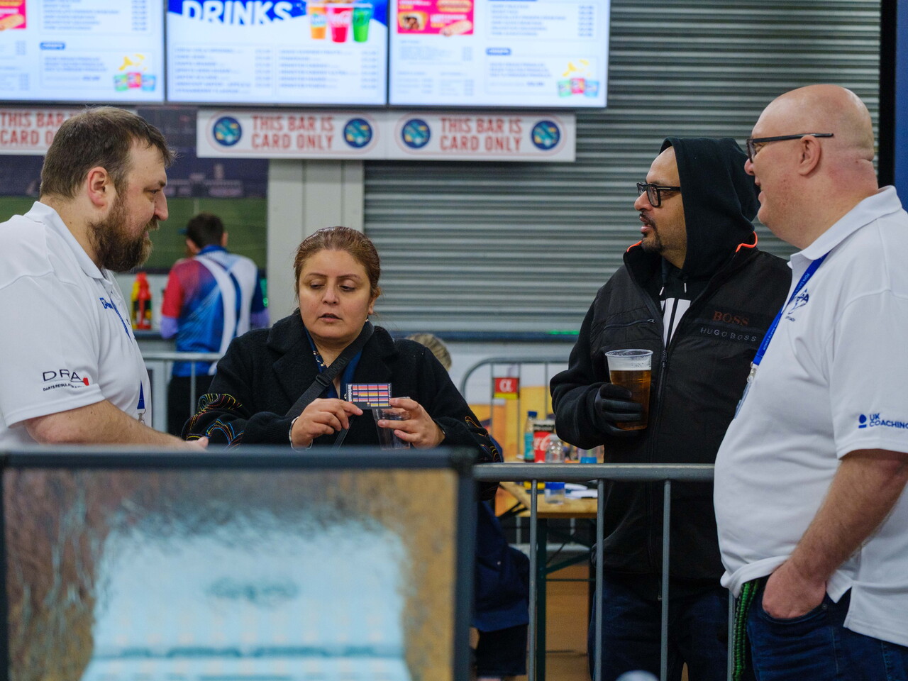 Darts Coach Uk team speaking to spectators during the junior competition