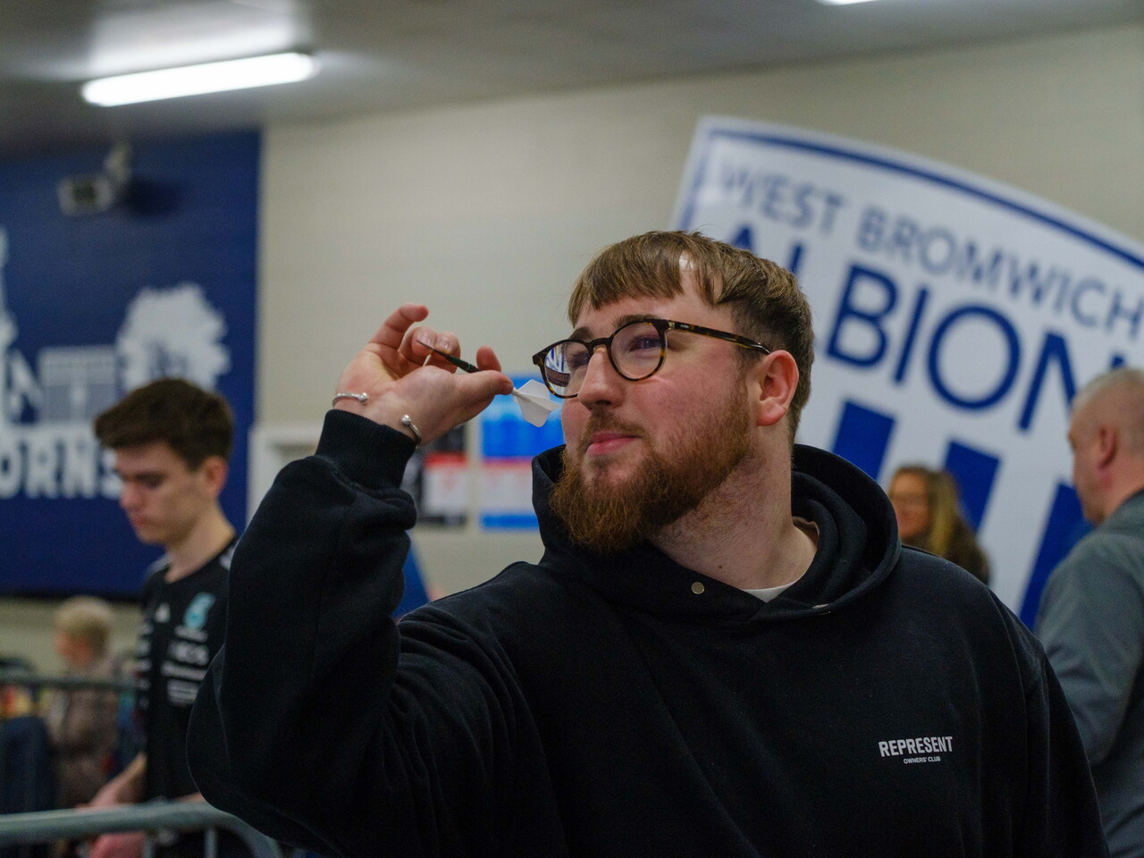 Adult player aiming his dart.