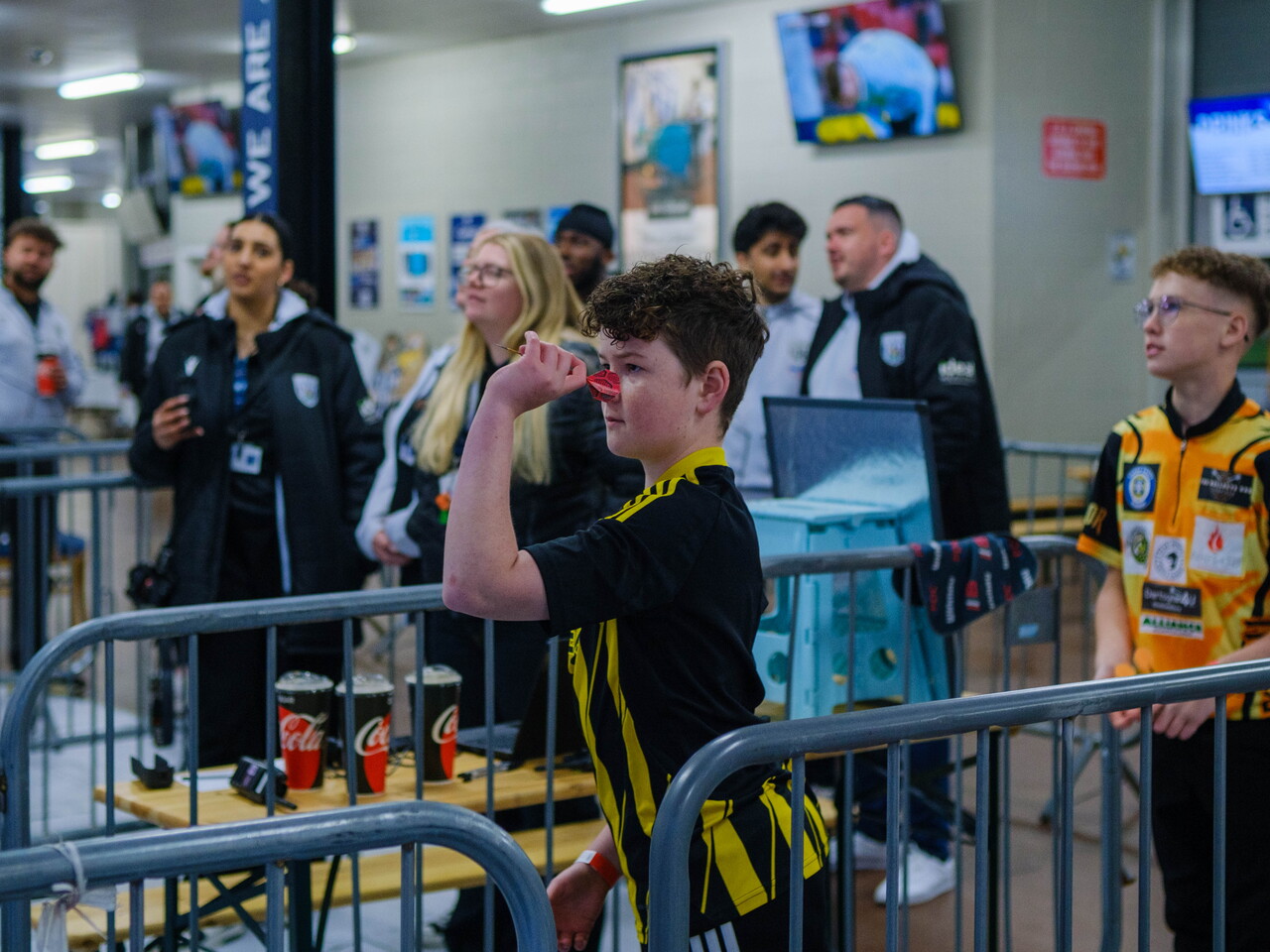 Junior darts player taking aim.