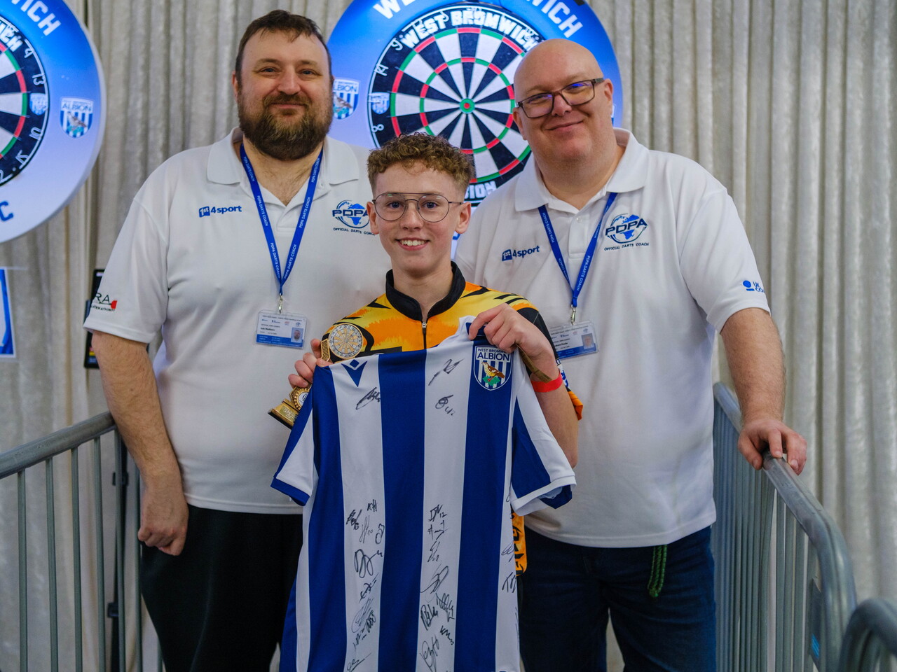Darts Coach Uk team present Codey with winners trophy and signed shirt