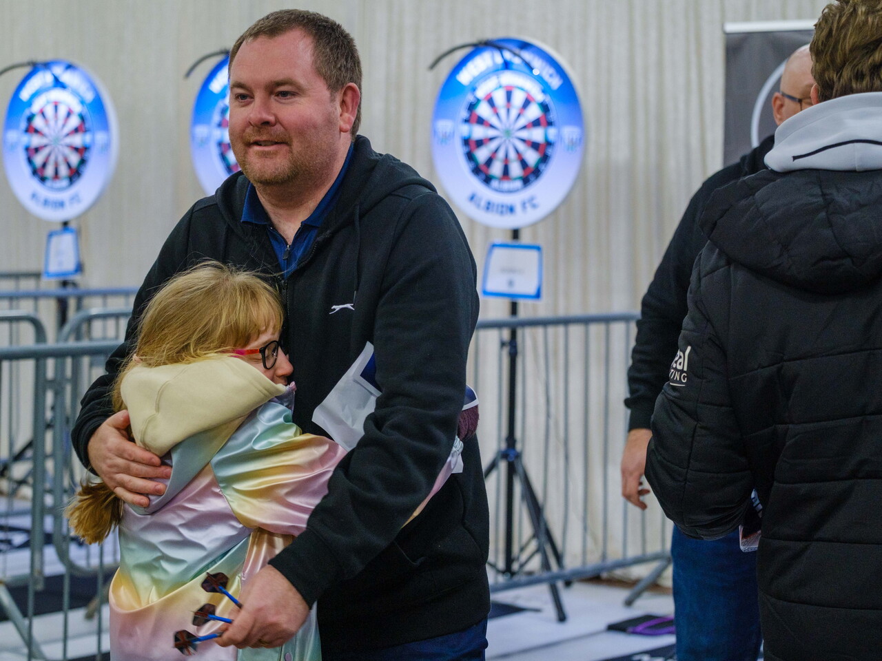 Carl Sparrow hugs his daughter after the conclusion of the game.