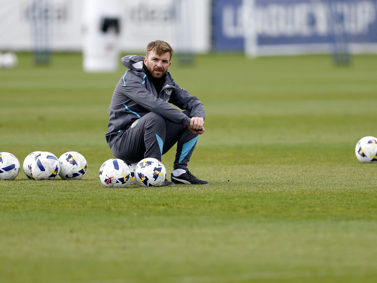James Morrison out on the training pitch sat on a football