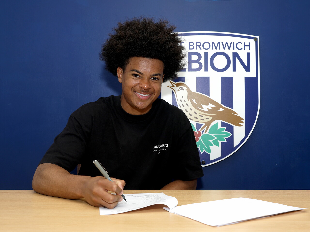 Maxwell Moses signing his first professional deal.