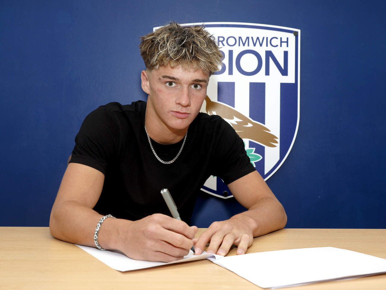 Harry French signing his first professional deal.