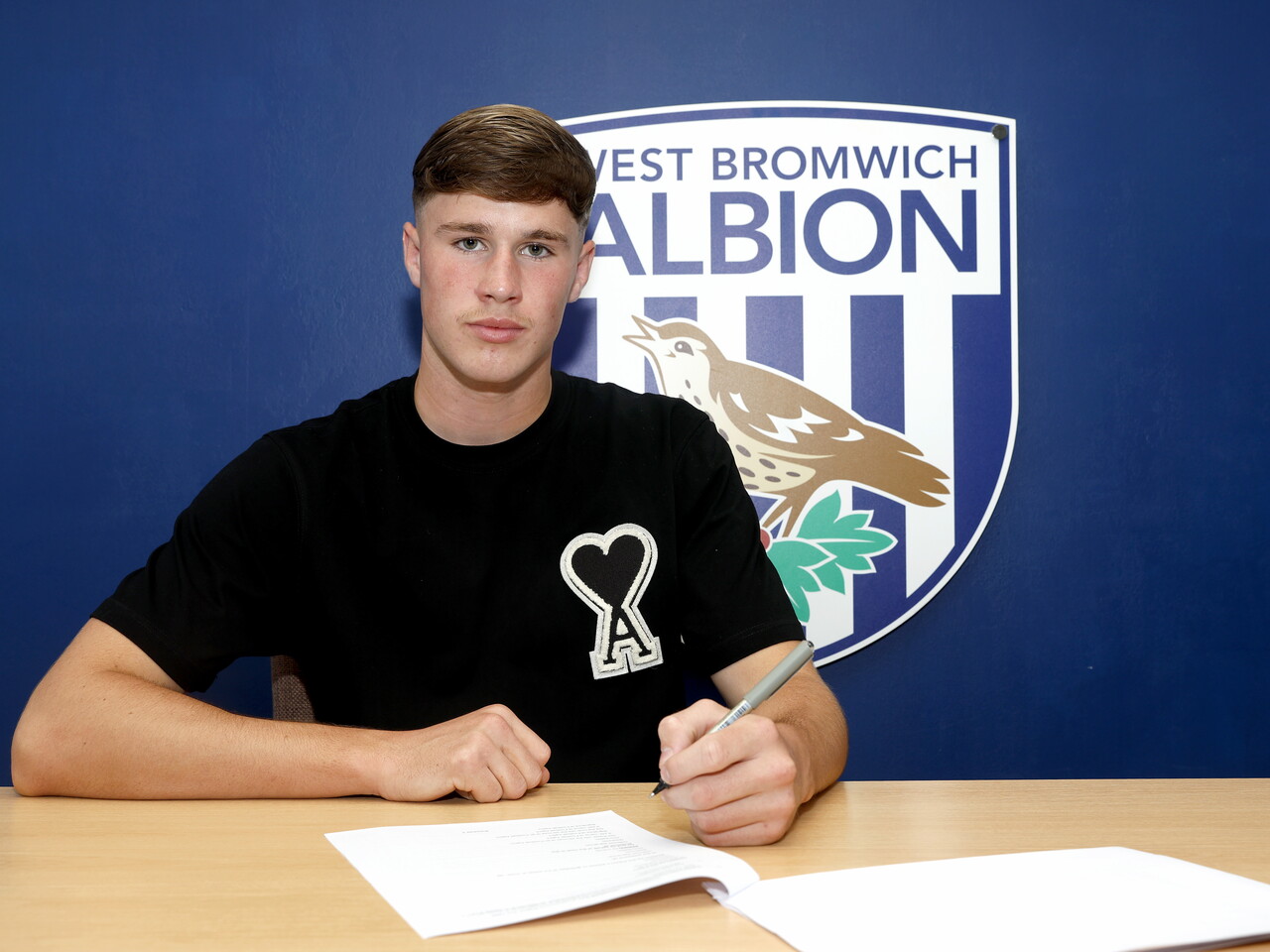 George Shaw signing his first professional deal.