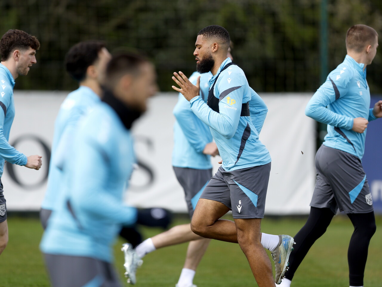 George Campbell warming up before a training session