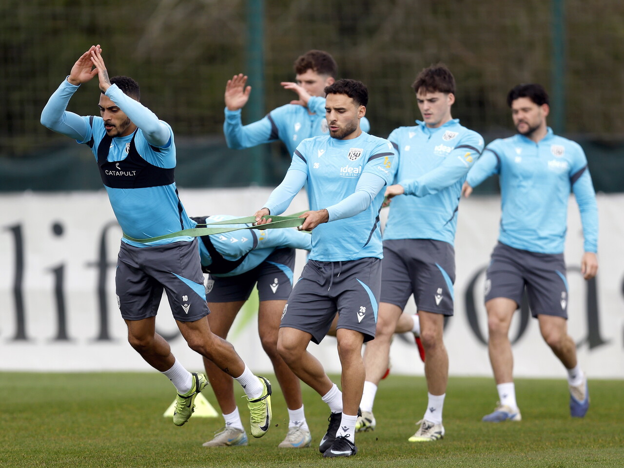Karlan Grant and Tammer Bany working with resistance bands during training