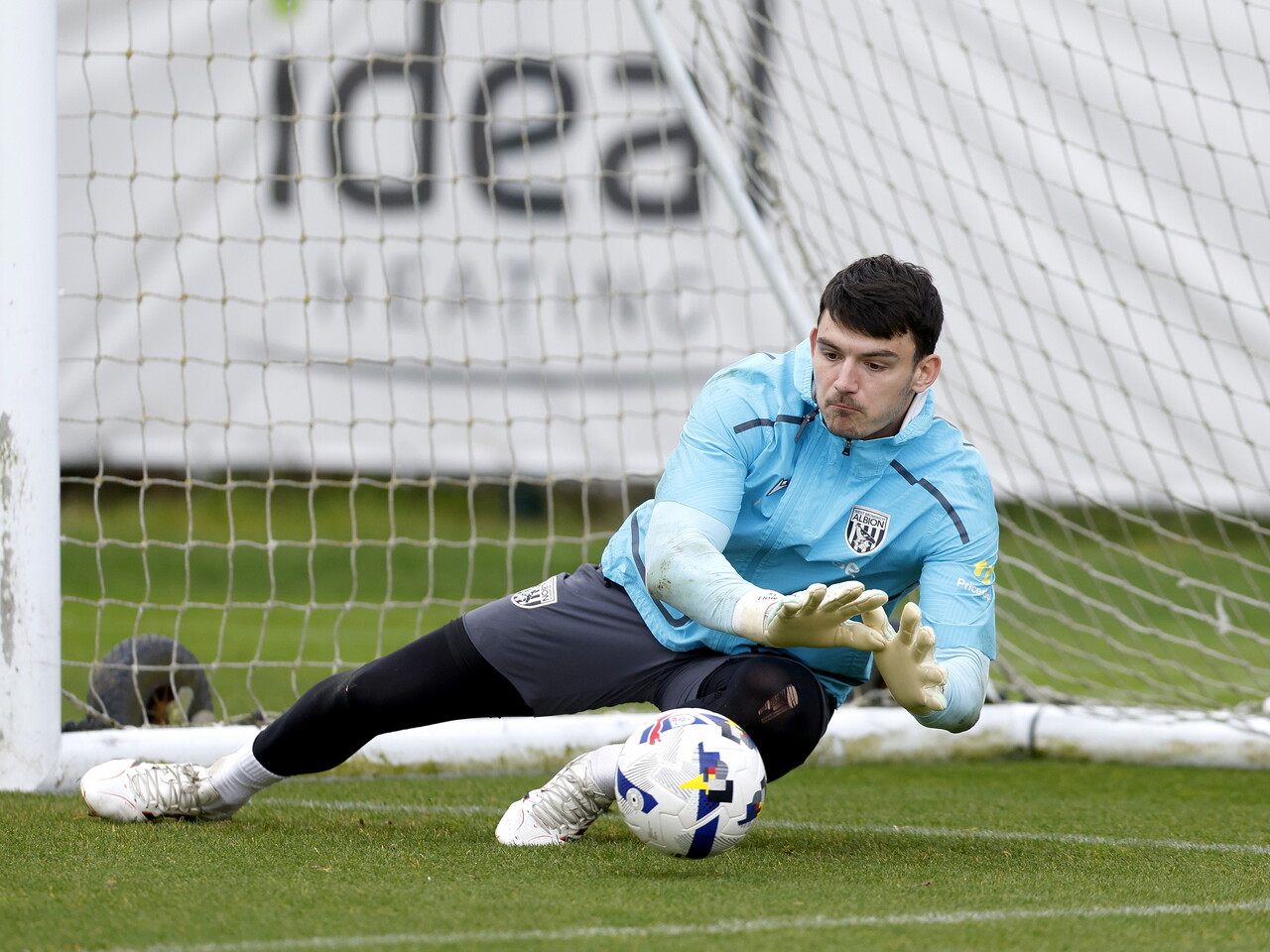 Max O'Leary diving on the ball during training