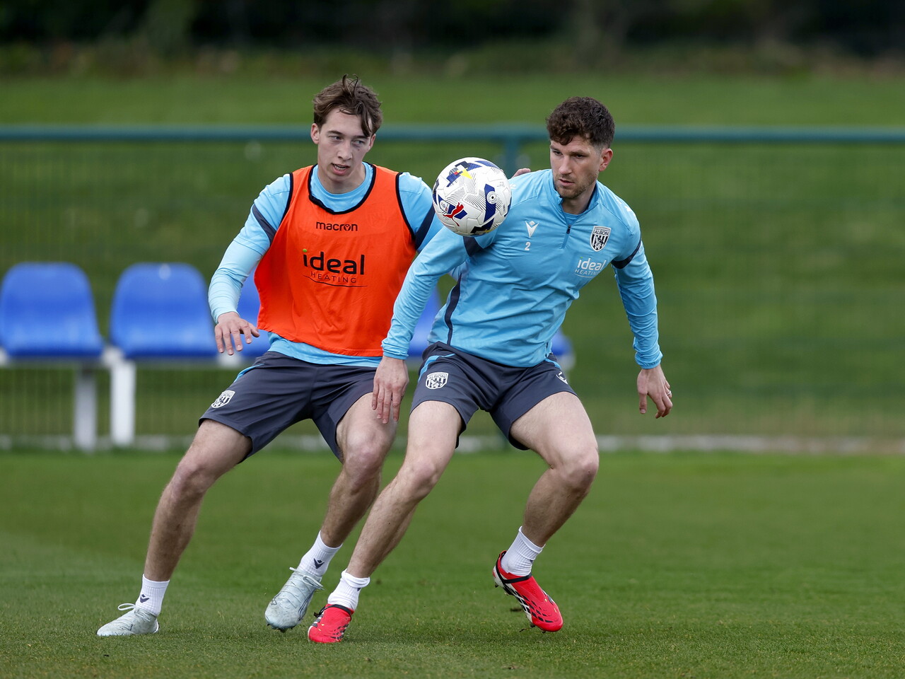 Harry Whitwell and Chris Mepham battling for the ball during training