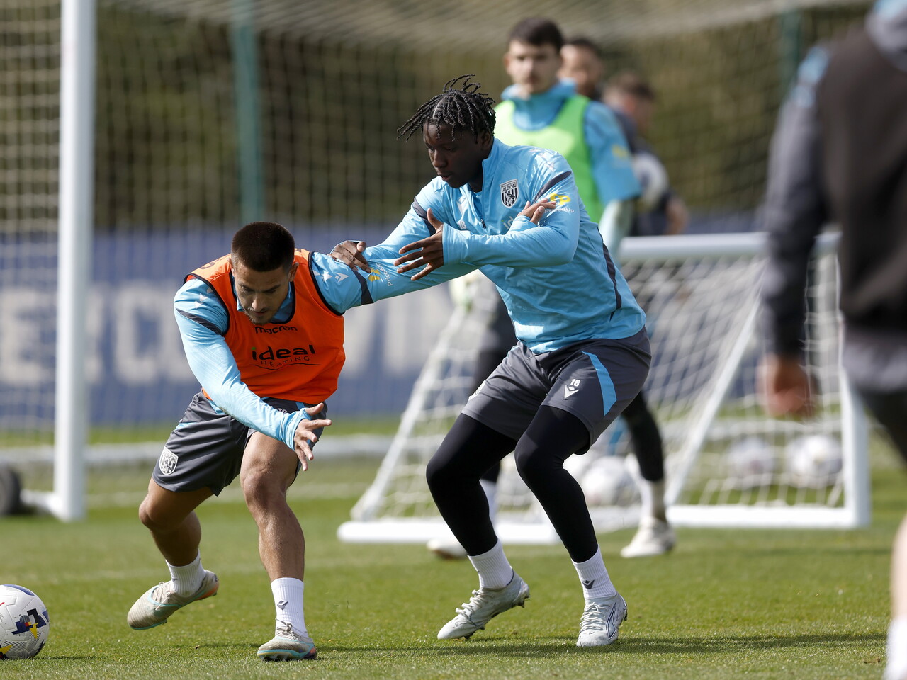 Danny Imray and Jamal Jimoh-Aloba battling for the ball during training