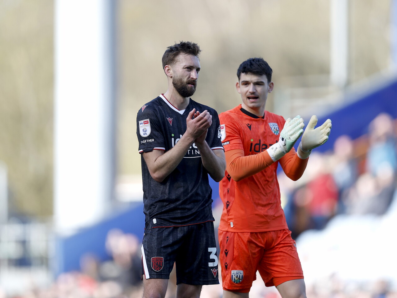Max O'Leary and Nat Phillips applaud the fans