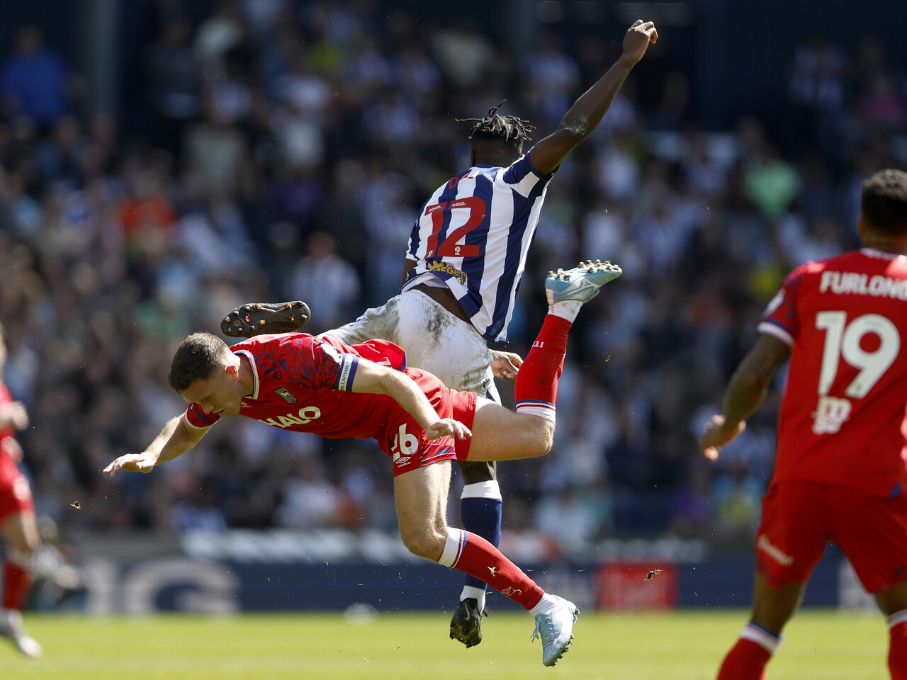 Daryl Dike jumping to win a header against Dara O'Shea of Ipswich 